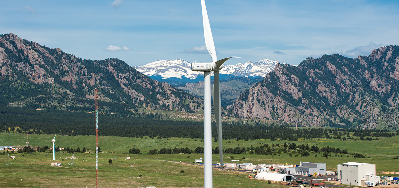 Photo of a wind turbine close-up with mountains in the background at NREL's National Wind Technology Center.