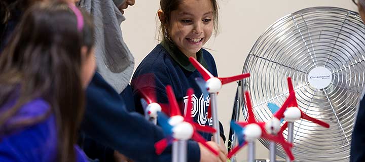 Students and a teacher at a hands-on wind energy experiment.