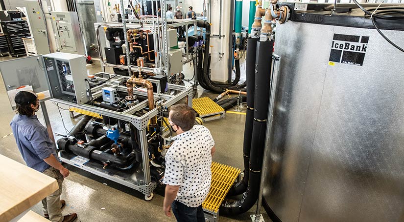 Workers in NREL's Energy Systems Integration Facility leveraging the chiller plant.