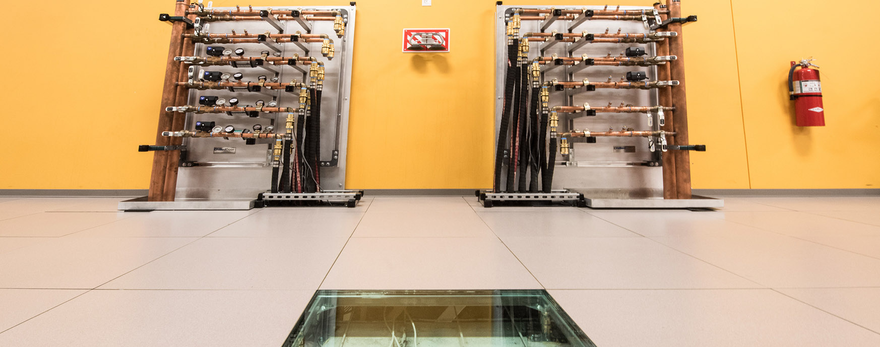 Photo of hot aisle containment manifolds in data center providing energy recovery water