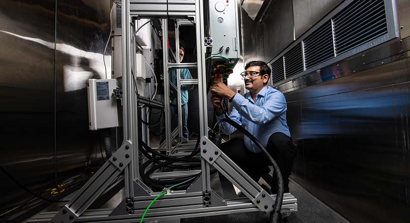 Photo of a researcher working on the residential battery test bed in the Energy Systems Integration Facility.