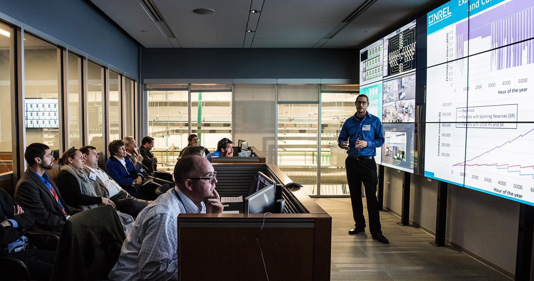 Photo of an NREL researcher presenting in the Energy Systems Integration Facility Control Room.