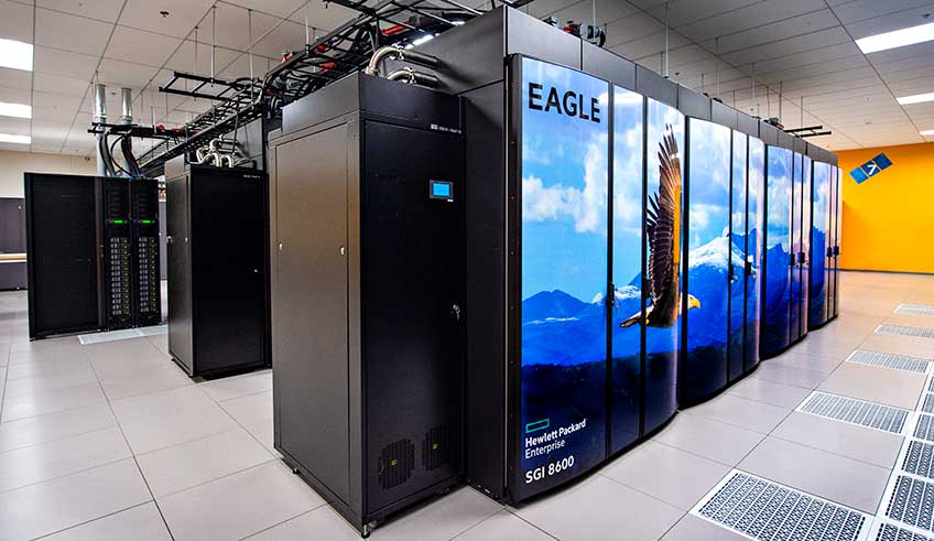 Computer stacks enclosed with doors that feature an image of an eagle flying in front of a mountain range across them
