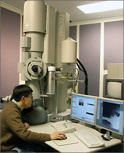 Photo of NREL researcher using transmission electron microscope.