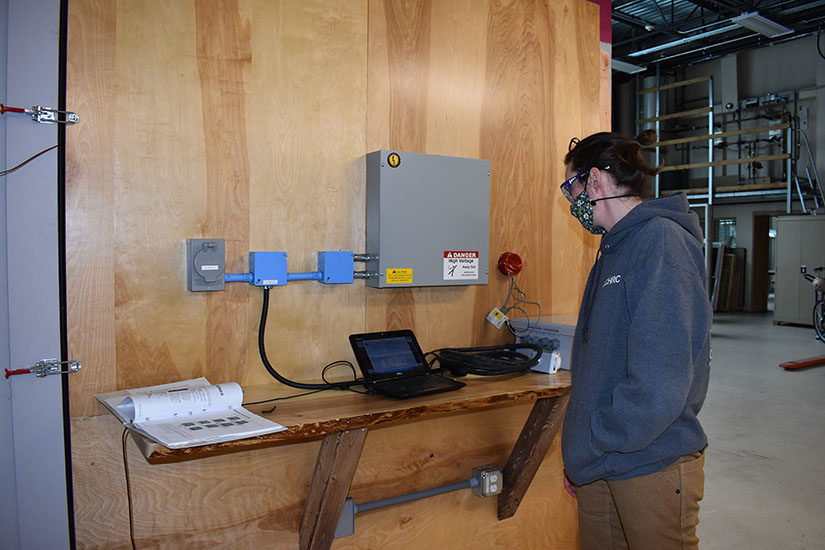Photo of a researcher calibrating a cold chamber