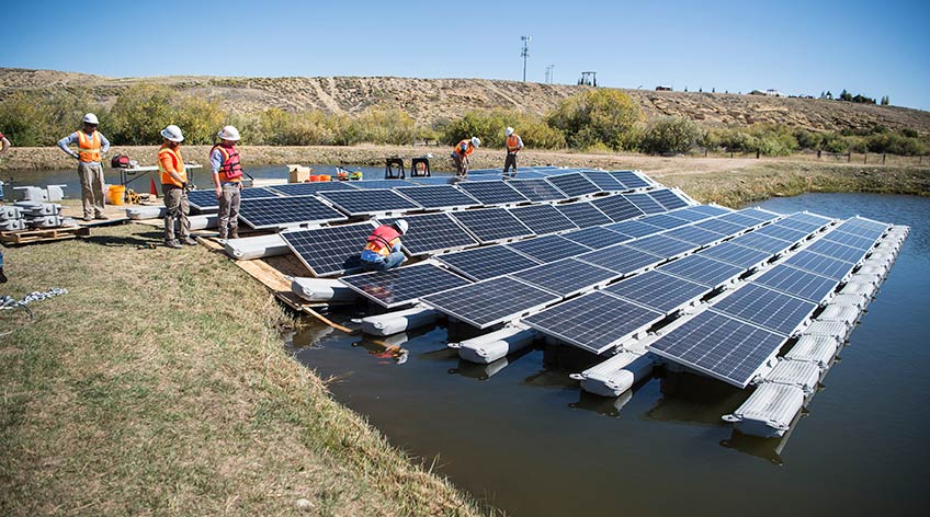 Photo shows solar panels floating on a body of water.