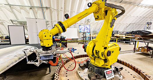 A stock image of a yellow robotic machine. 