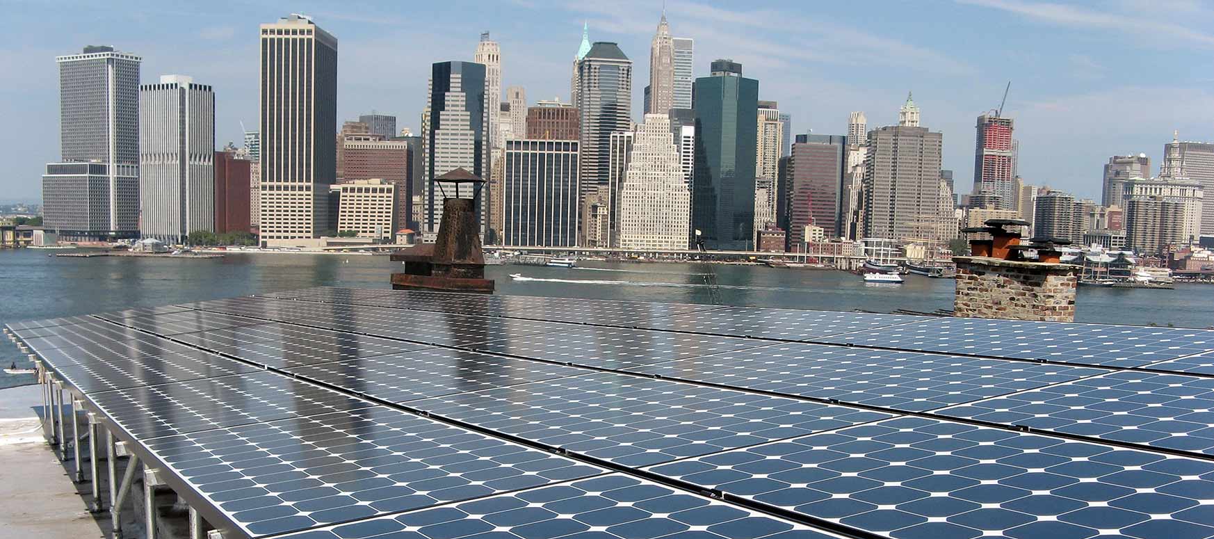 Photo of a photovoltaic array, harbor and New York City skyline