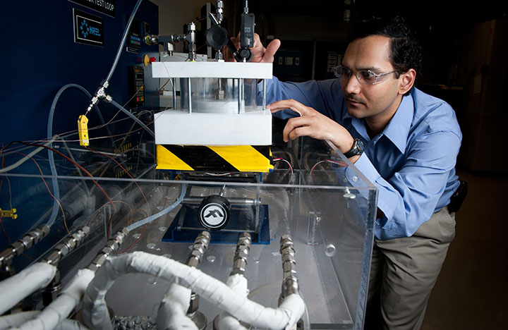 A researcher works on equipment in NREL's Advanced Power Electronics Lab.