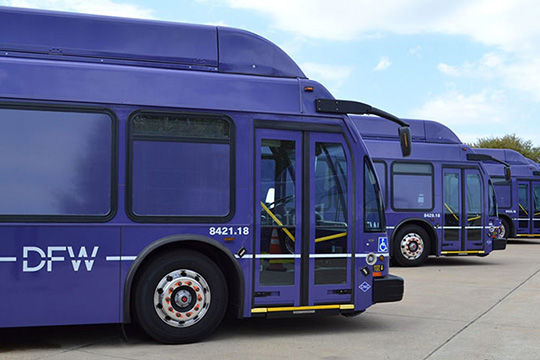 A row of buses at Dallas Fort Worth International Airport.