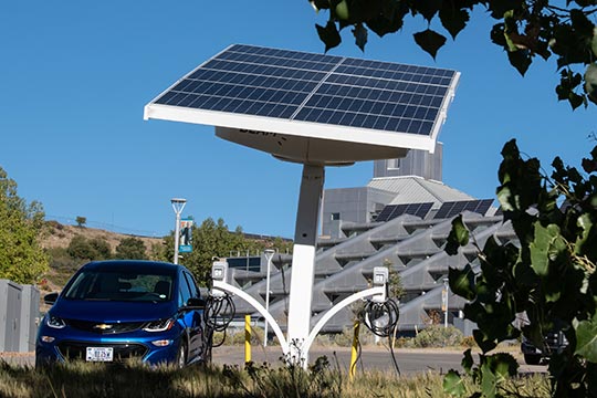 A Chevy Bolt charges its batteries with a solar panel