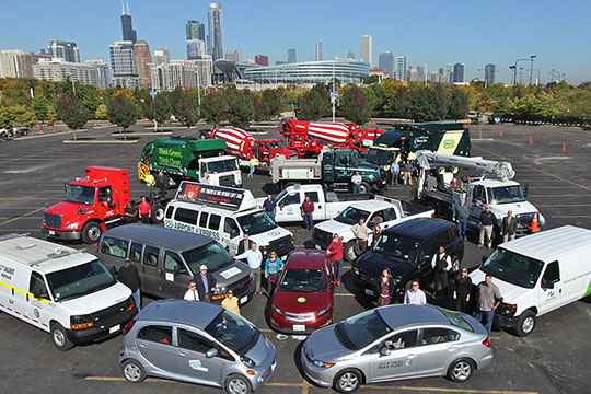 A group of alternative low-, medium-, and heavy-duty vehicles in a parking lot.