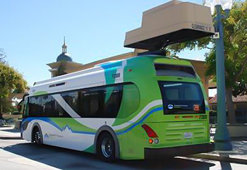 Photo of transit bus and overhead charging unit.