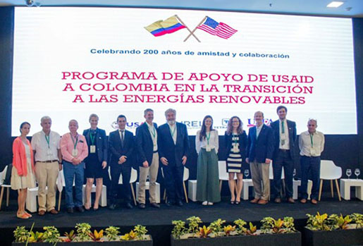 The USAID-NREL Colombia program team stands in front of a screen at the World Energy Council Conference in Barranquilla, Colombia.