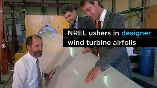 A photo of three men touching a wind turbine blade.