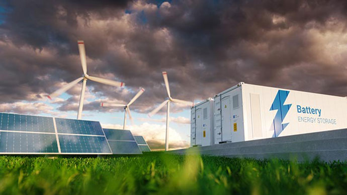 Photo of an outdoor scene with solar panels, wind turbines, and battery storage.