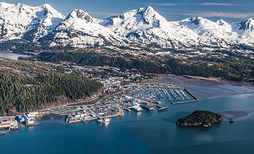 An aerial photo of mountains and a harbor.