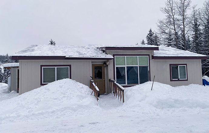 Photo of a house surrounded by snow