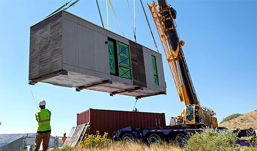 A prototype of a prefabricated housing unit–called a Blok–is lowered into place on NREL’s Golden, Colorado, campus as part of the IN2 program.