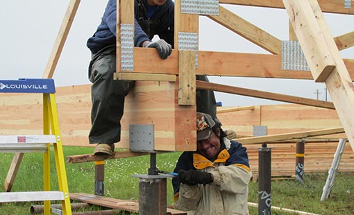 Two men using power tools