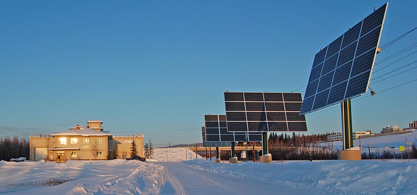 Solar panels stand in the snow at the Cold Climate Housing Research Center in Fairbanks, Alaska.