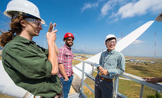 NREL interns Julian Quick and Kevin Wu enjoy their tour of the Cart 3 research turbine at the NWTC.