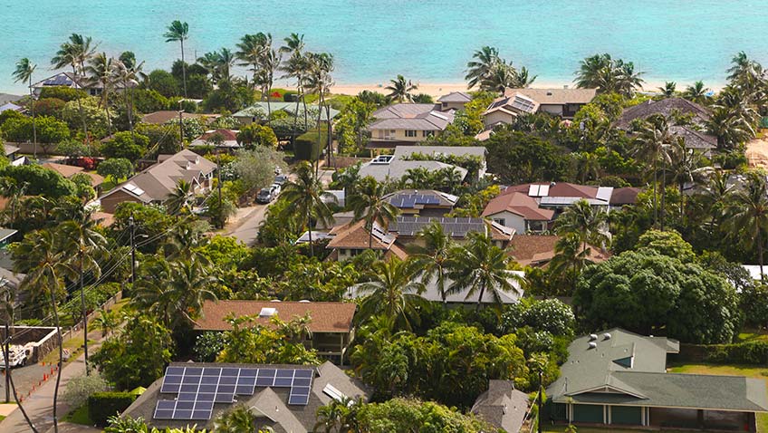 Aerial view of homes with solar panels in Hawaii.