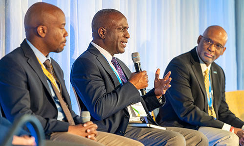 Three people on stage during panel discussion.