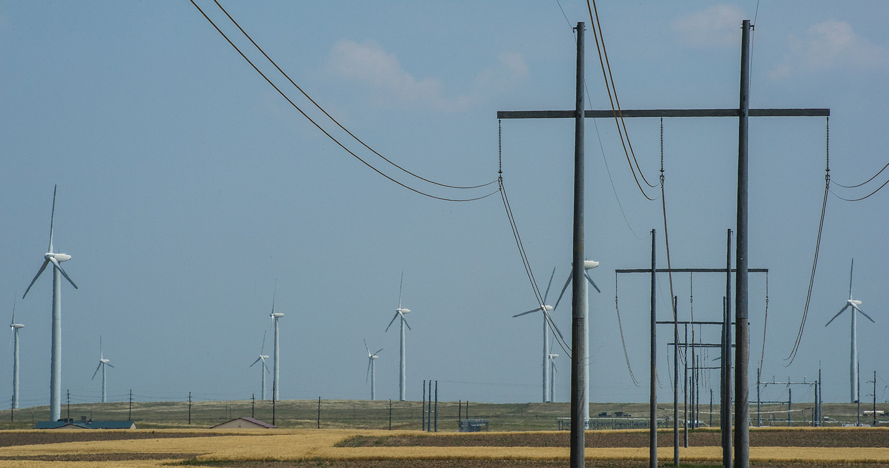 Photo of transmission lines and wind turbines.