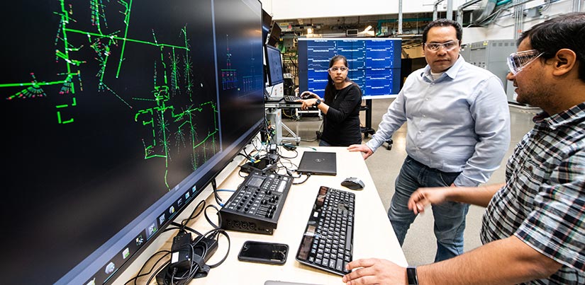 Researchers discuss a power system model.