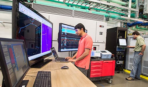 NREL researchers testing a power hardware-in-the-loop co-simulation.