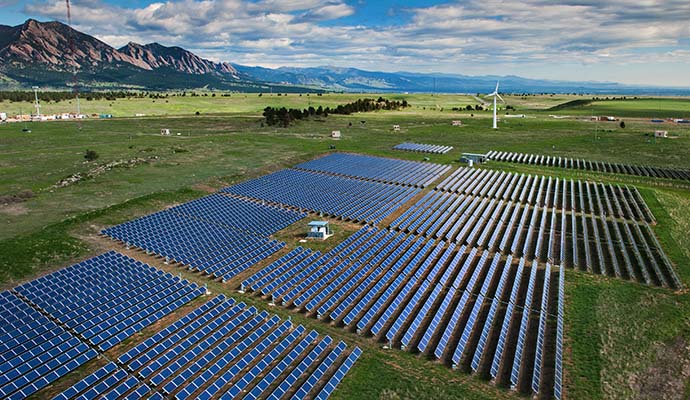 Aerial view of PV arrays and wind turbines at NREL's Flatirons Campus 