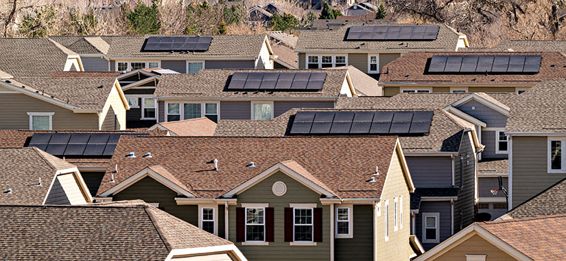 Solar panels mounted on rooftops in neighborhood