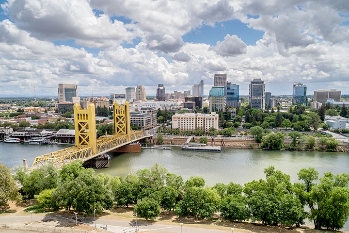 Aerial view photo of Sacramento's Tower Bridge and the Sacramento River, looking towards the Capitol mall and building.