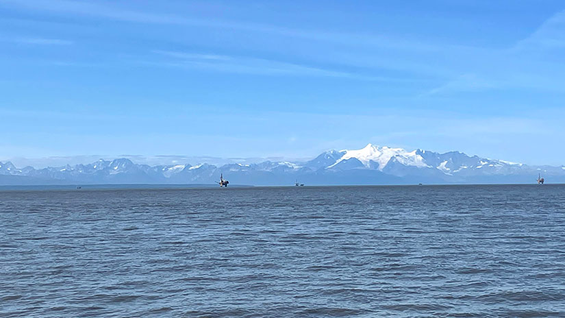 202404-newsletter-alaska-offshore View of inlet water in Alaska with wind turbines in distance
