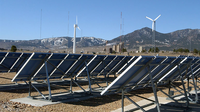 wind-grid-systems-fullwidth-12530 Solar panel array with wind turbines in the background