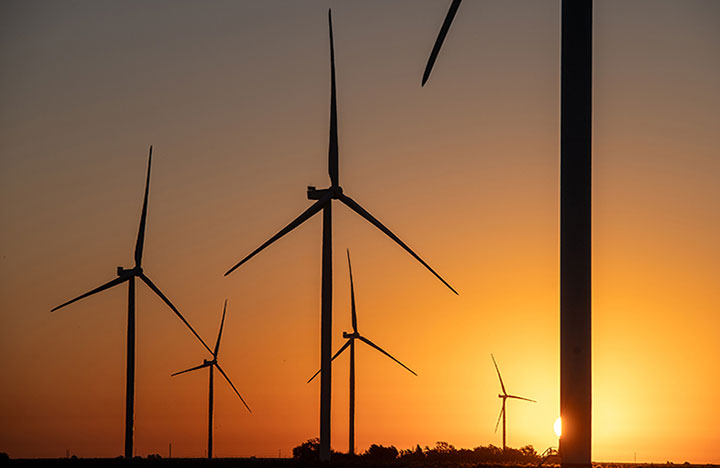 20240506-nrels-ai-work-reveals-benefits-to-wind-industry-841 Wind turbines in a field during sunset