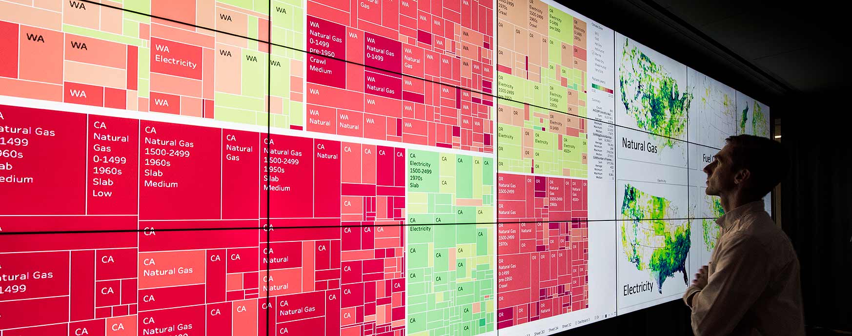 hero-dataviz-wall-45438 Photo of a man viewing a large display of information.