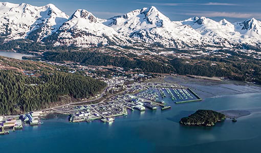 impacts-istock-1282751408 Aerial view of the shoreline of Cordova, Alaska with mountain range in the background