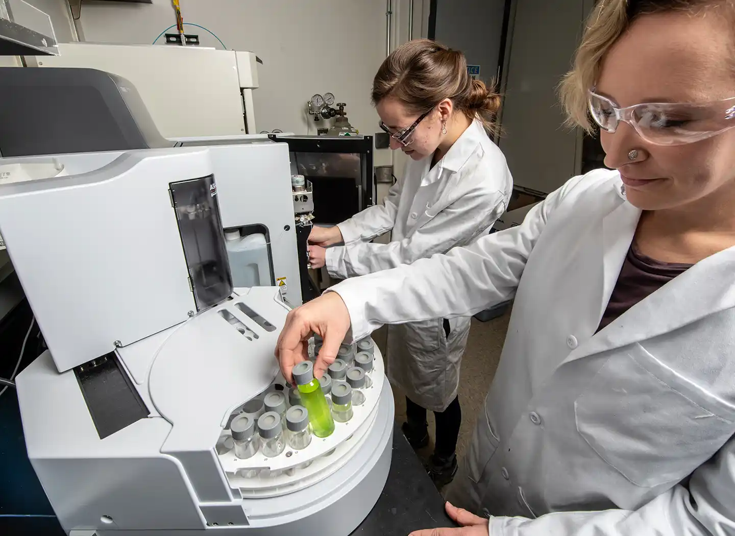 Two researchers work in a bioenergy lab.