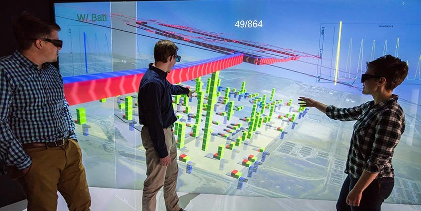 Researchers look at a 3D building model in the visualization lab at NREL.