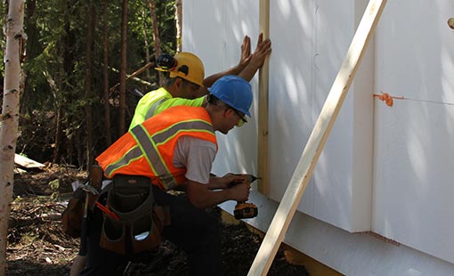 extreme-climates-1 Two men using power tools.