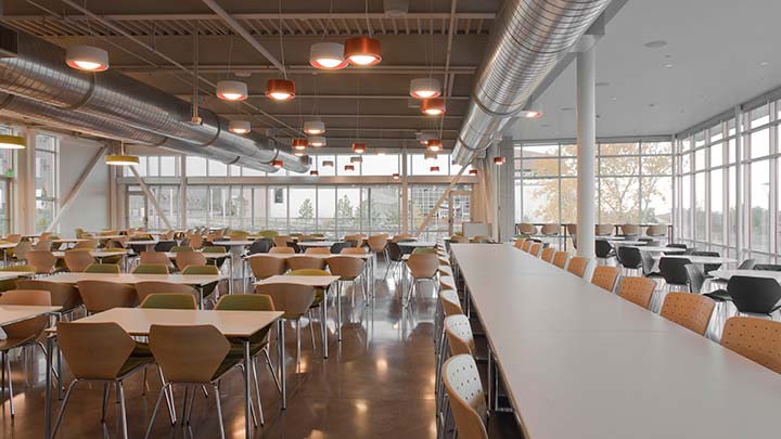 facilities-cafe-32295-tn Empty tables and chairs in a cafeteria.