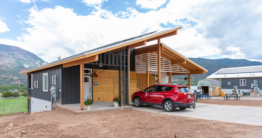 A house and parked car.