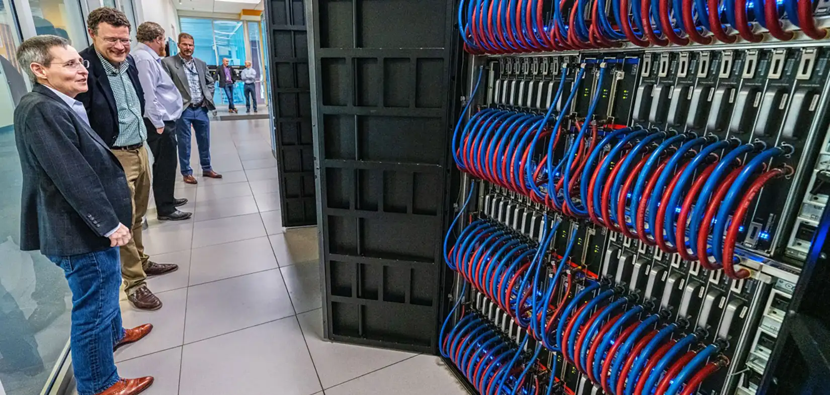 A large crane lowering a structure with a worker in the foreground.