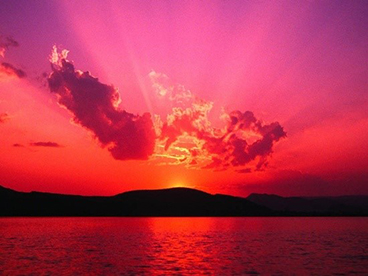 figure-1-caption-sunset-smith Photo of a sunset over the ocean and mountains