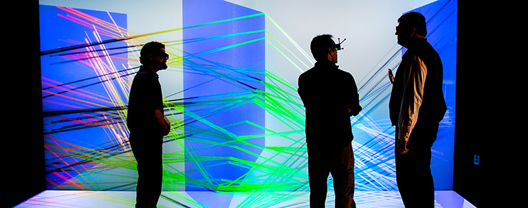 fac_33710 Photo of three people viewing a large-scale 3D visualization
