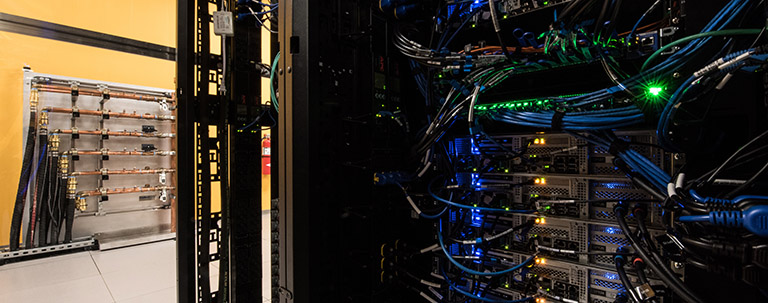 fac_42014 Photo of hot aisle containment manifolds in data center