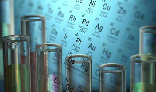 research-materials-database-istock-518264135 Periodic table in the background with beakers in front of it