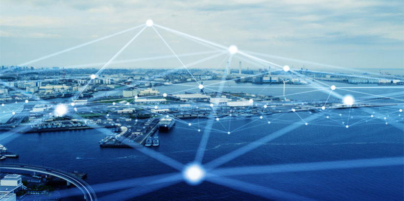 Lens view of a city next to an ocean with a connected technology web hovering above it.